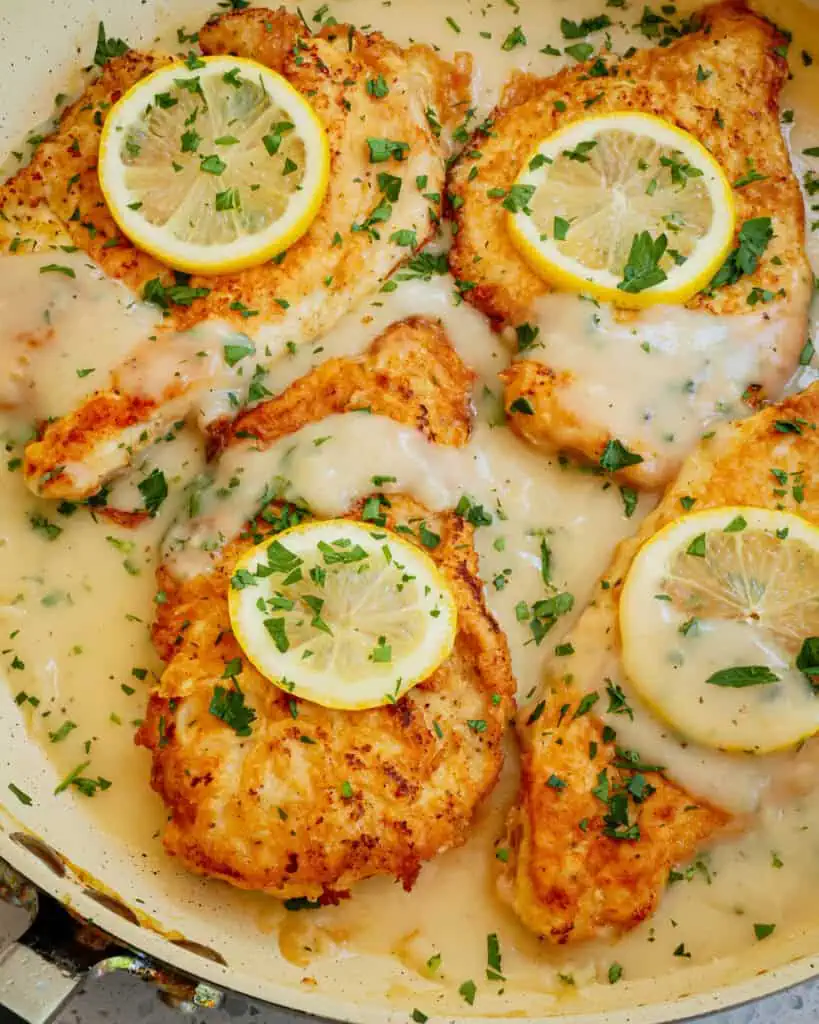 Delicious Italian American Chicken Francese with chicken cutlets dredged in flour, dipped in beaten eggs, and pan fried crisp and served in a lemon white wine sauce. 