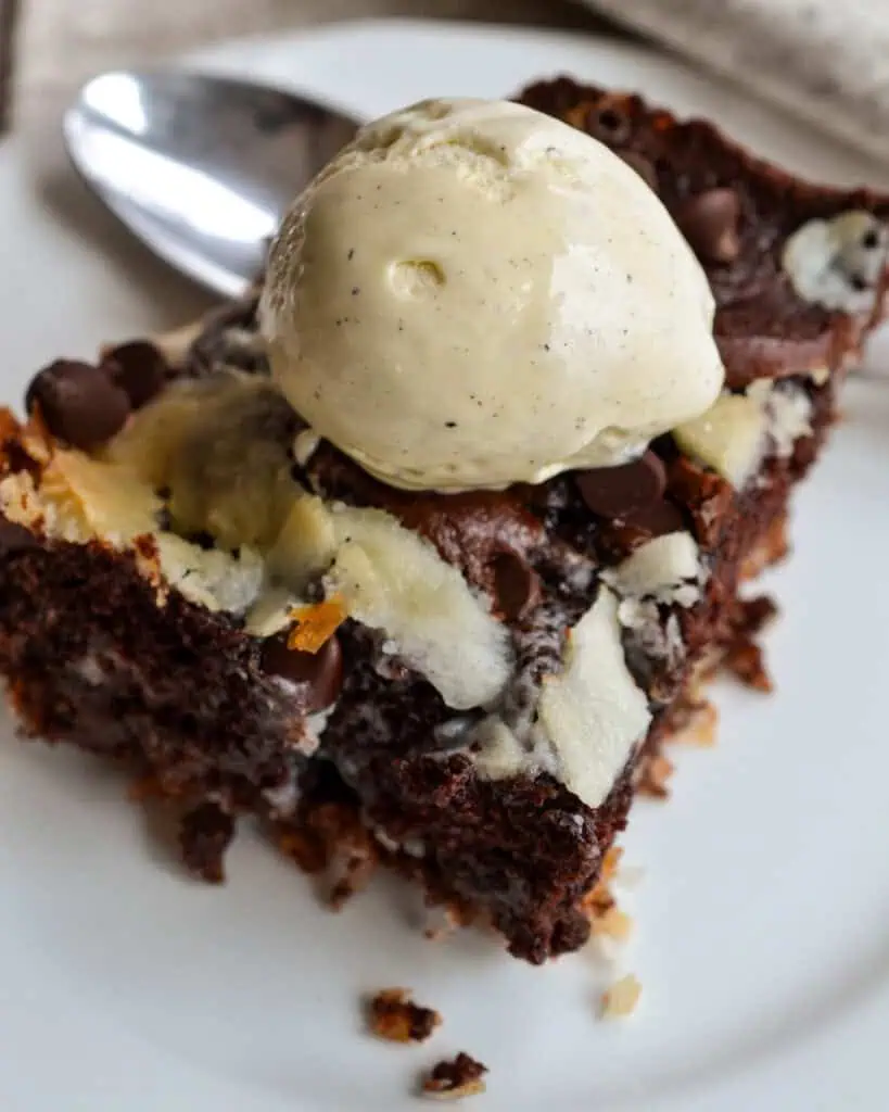 A slice of earthquake cake with vanilla ice cream. 