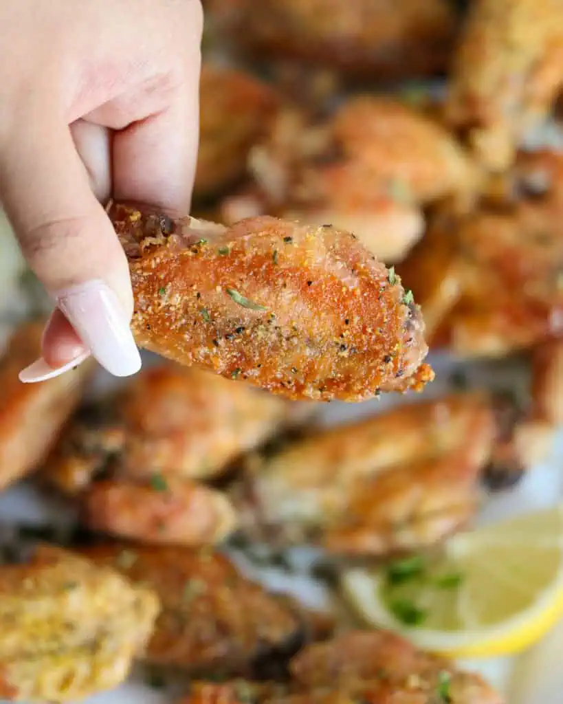 A close up view of a lemon pepper chicken wing flat. 