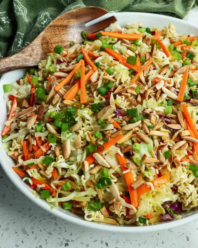 A closeup view of ramen noodle salad. This crunchy Ramen Noodle Salad combines green cabbage, red cabbage, ramen noodles, green onions, carrots, and toasted almonds all tossed in a honey garlic ginger sesame dressing