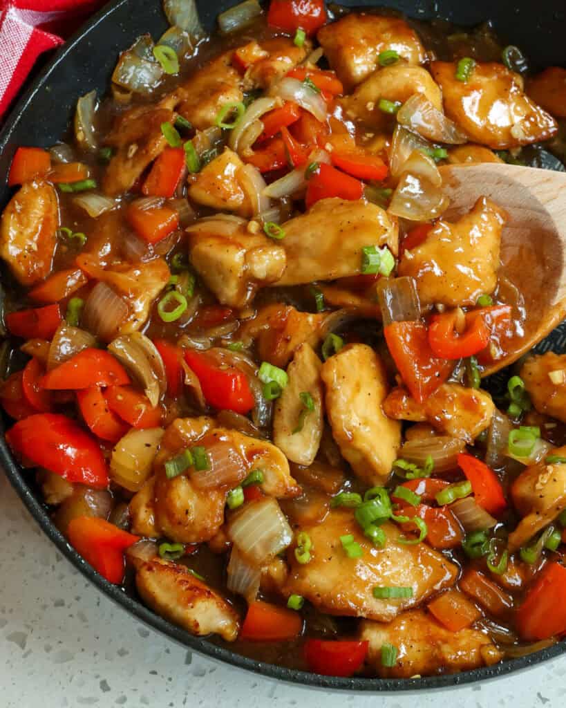 Black Pepper Chicken combines stir-fried chicken breasts, onions, and red bell pepper seasoned with garlic and ginger in a sweet and savory black pepper sauce.