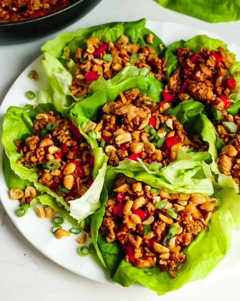 An overhead view of chicken lettuce wraps on a serving platter. 