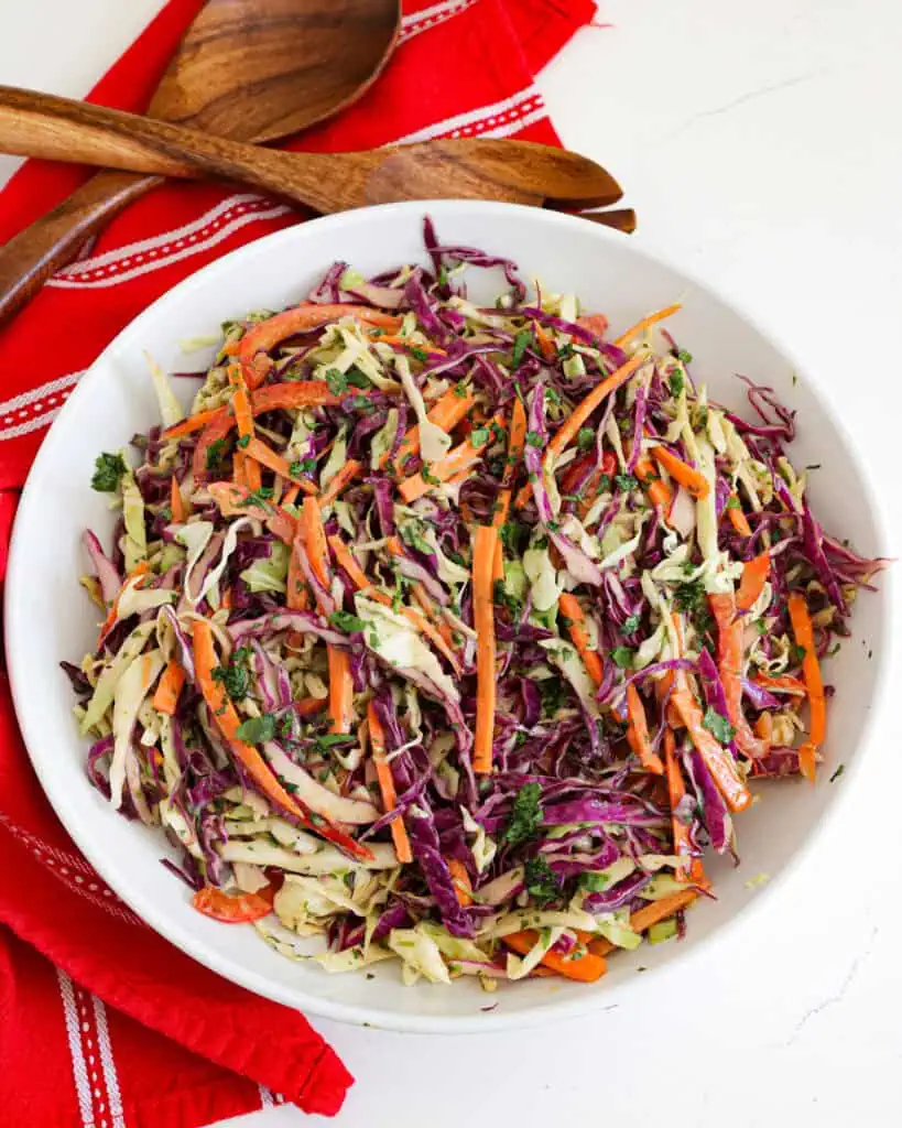 All the ingredients for Asian slaw in a large bowl. 