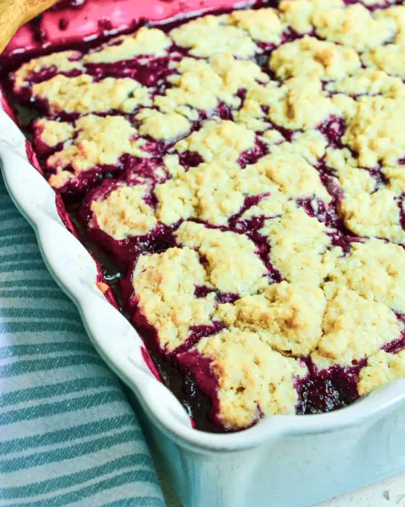 A 9-inch square baking dish full of blackberry cobbler.  