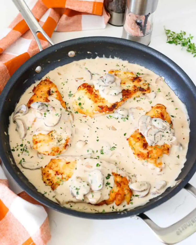 Four lightly breaded golden brown chicken breasts, topped with cremini mushrooms, and shallots in a rich, creamy marsala sauce. 