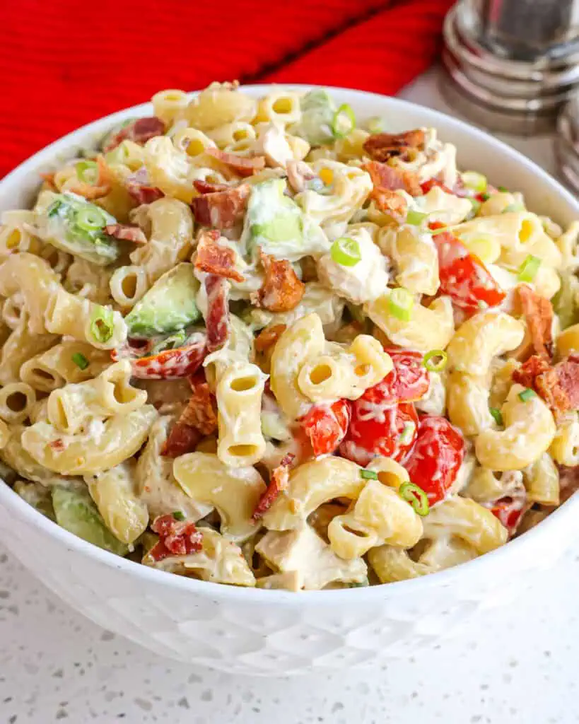 A quick and easy cold Pasta Salad made with already cooked chicken, crispy smoked bacon, tomatoes, and creamy avocadoes, all in a lightly sweetened garlic mustard mayonnaise-based dressing. 