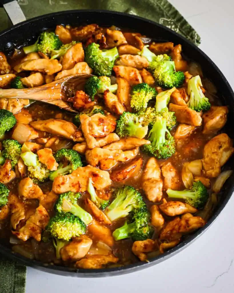 Stir Fried Chicken and Broccoli in a honey ginger stir fry sauce in a skillet. 