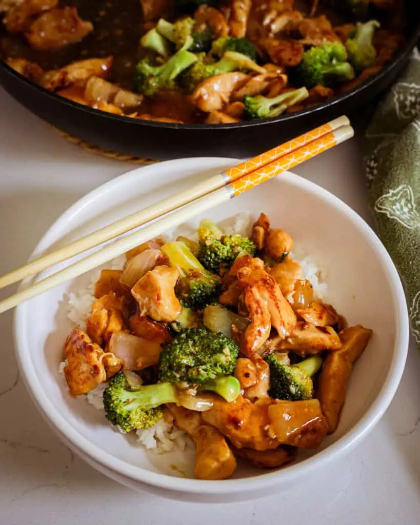 Stir fried chicken and broccoli in a small single serving bowl. 