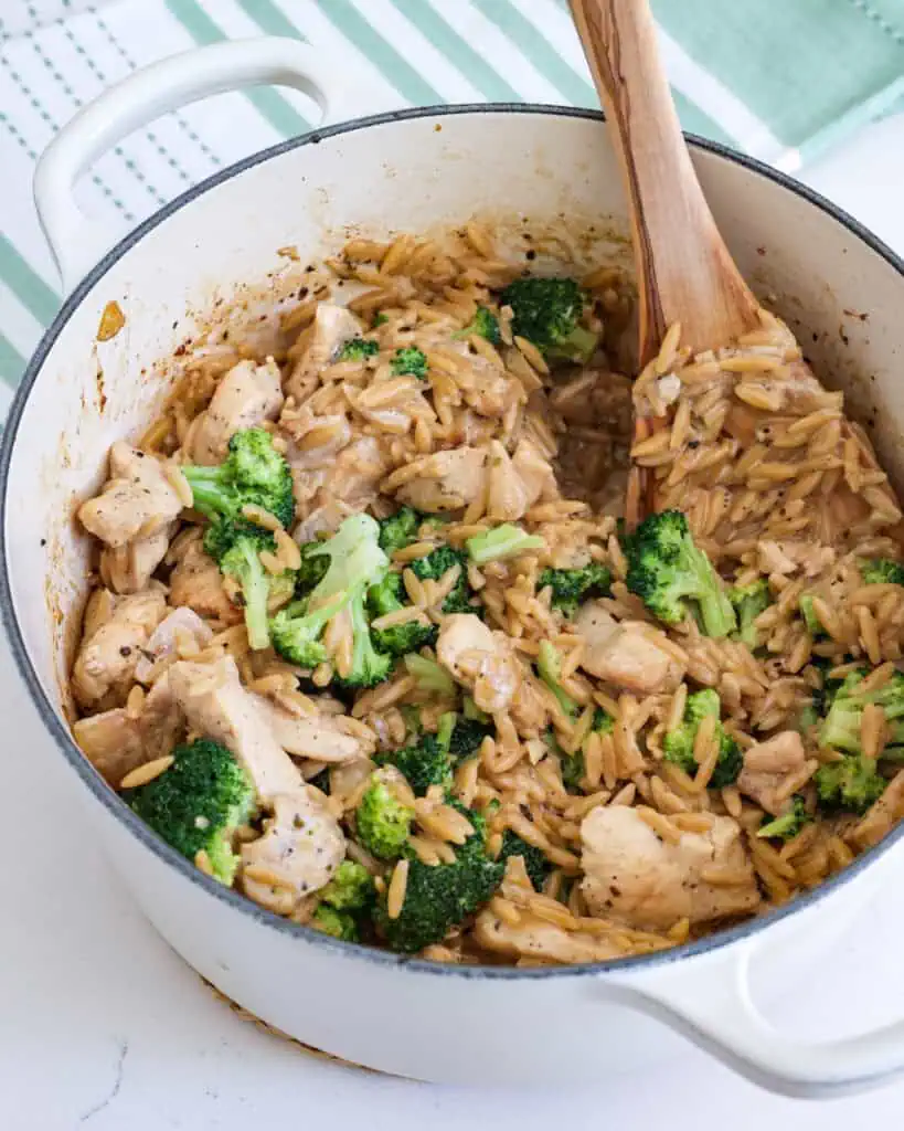 Creamy chicken and orzo in a large pot 