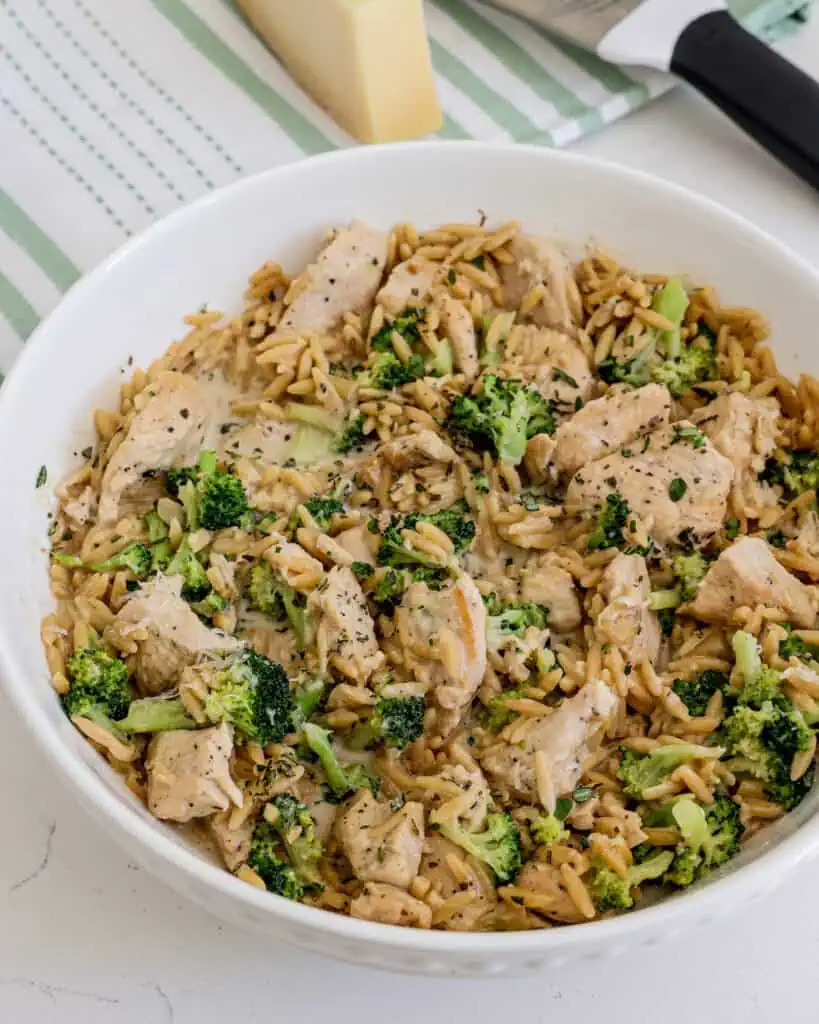Creamy chicken and orzo with broccoli and broccoli in a bowl. 