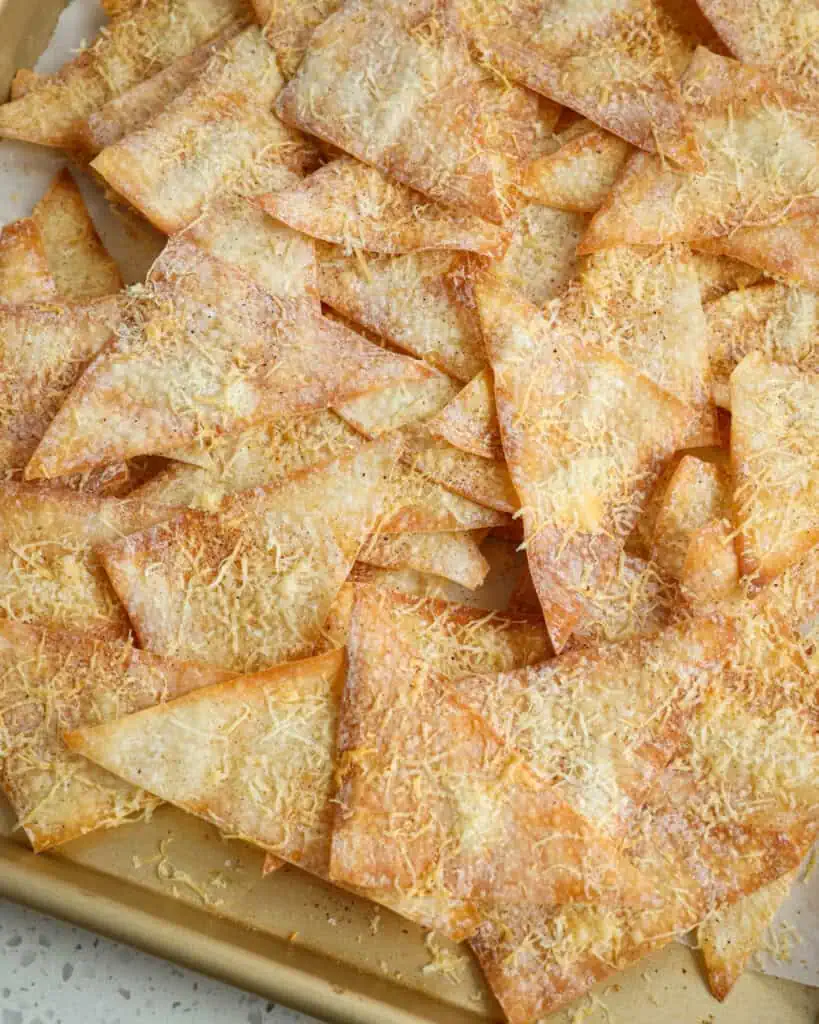 A baking sheet of fresh baked wonton chips. 