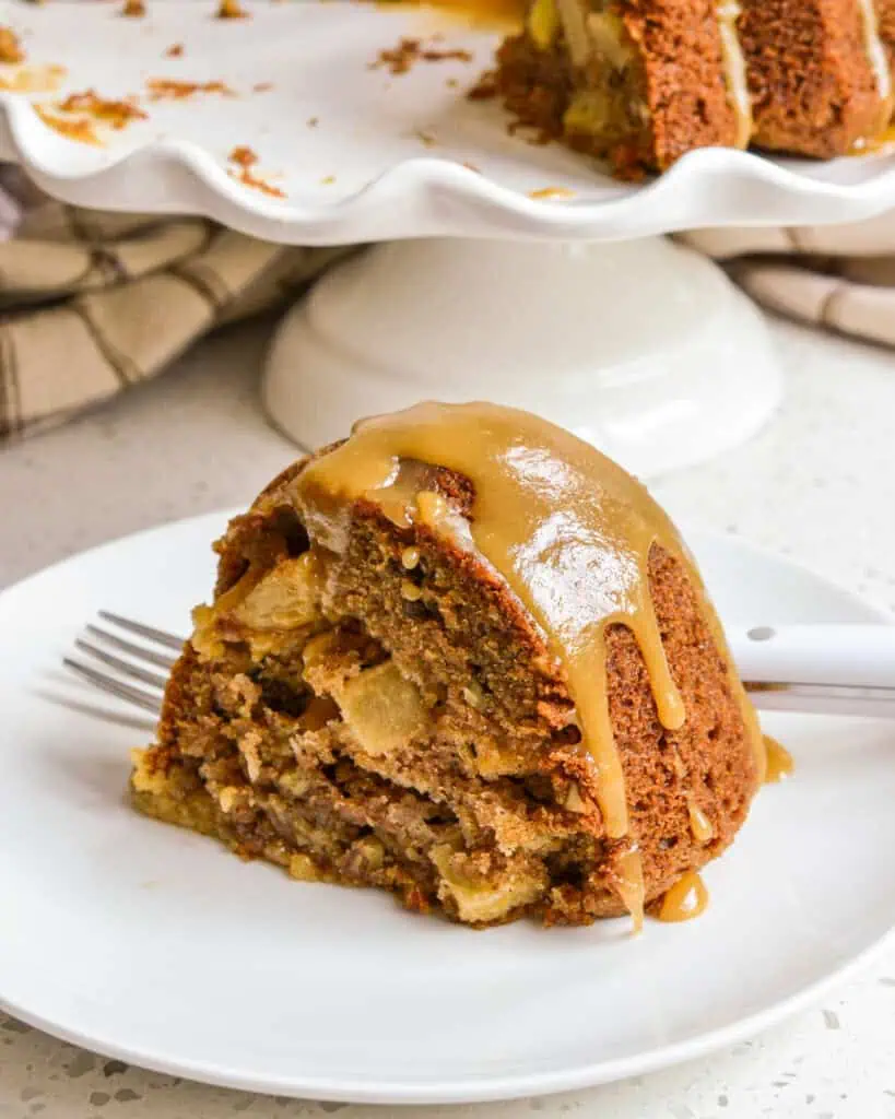 A single slice of apple cake with a caramel drizzle over it. 