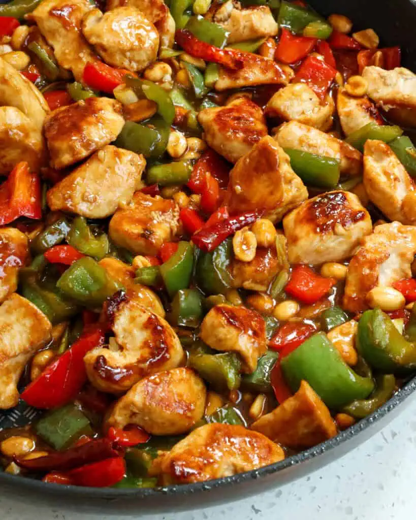 Kung Pao Chicken is the ultimate stir fry experience.  It is loaded with delicious peppers, scallions and peanuts in a sweet and salty slightly spicy sauce. Make this favorite takeout dish at home for a delicious experience!
