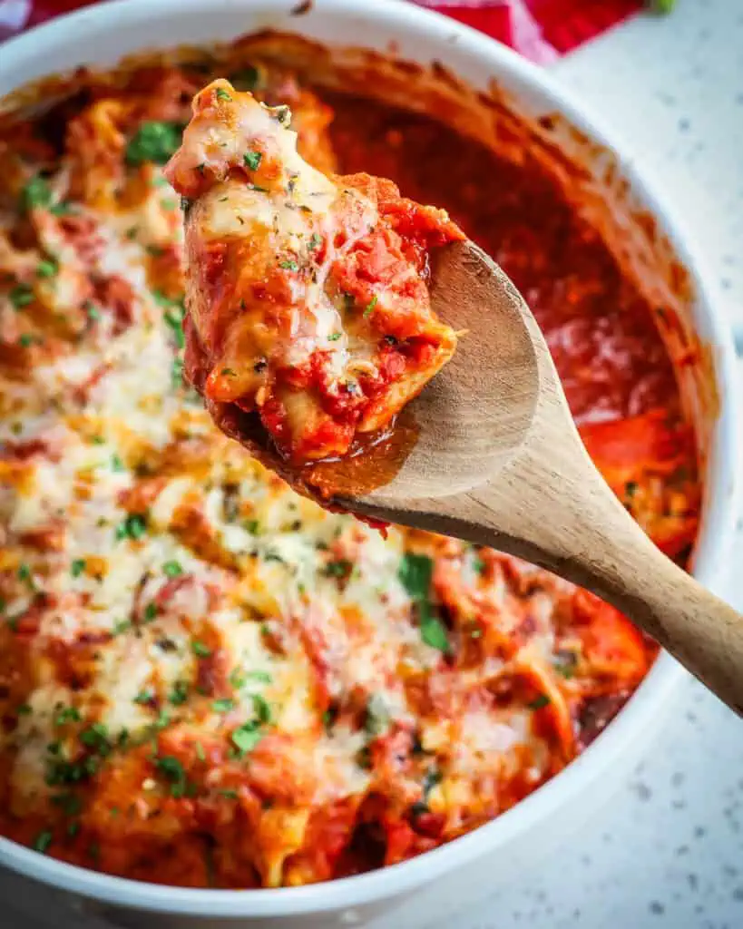 A casserole full of ricotta stuffed shells with spinach and garlic.