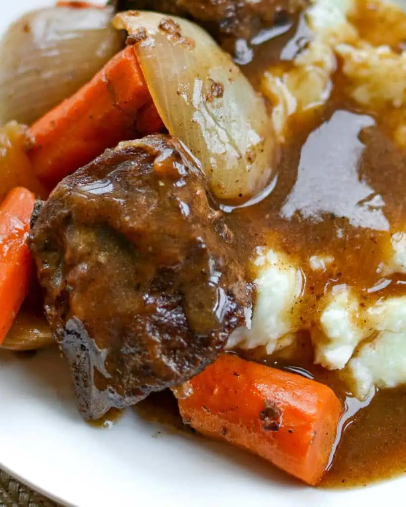 Beef short ribs with gravy over mashed potatoes