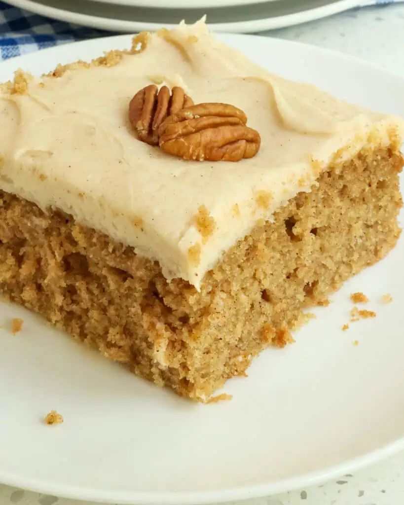 A close up view of a pieces of applesauce cake with cream cream frosting. 