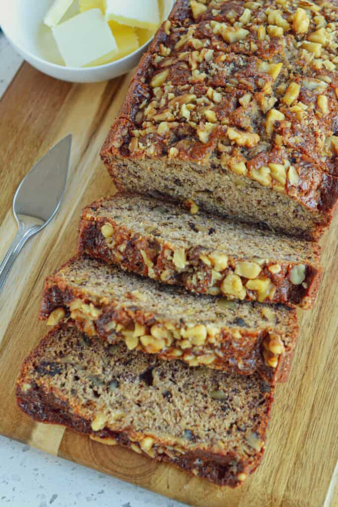 Sliced banana nut bread on a cutting board. 