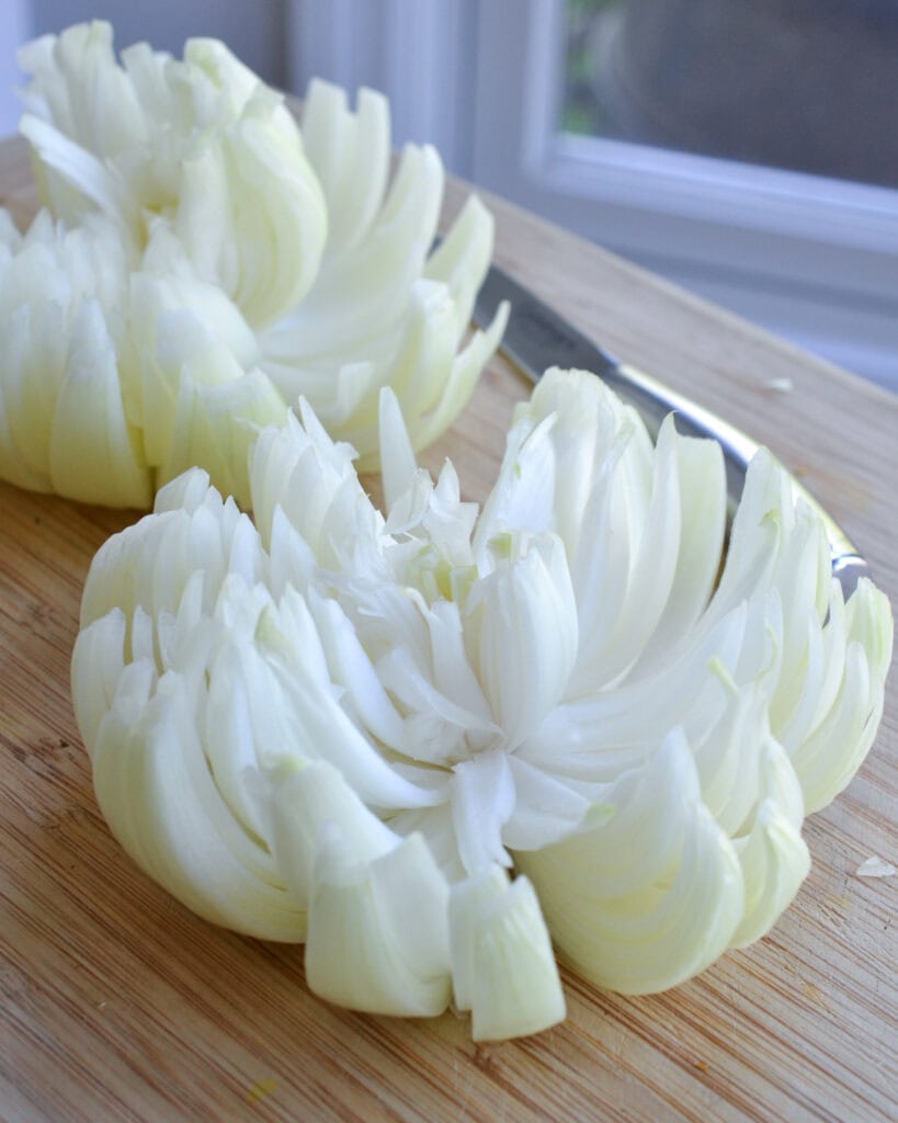 Two onions cut and ready for breading to make blooming onions. 