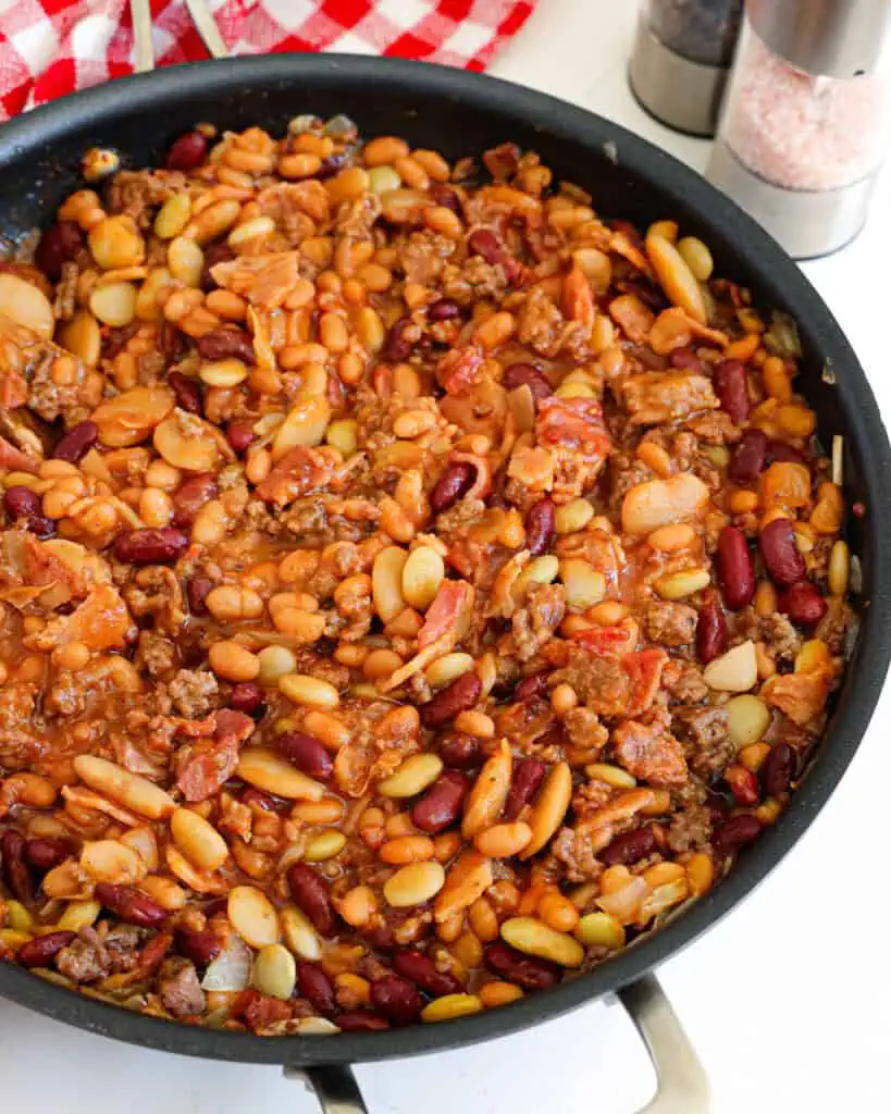 Simmered calico beans in a large skillet. 