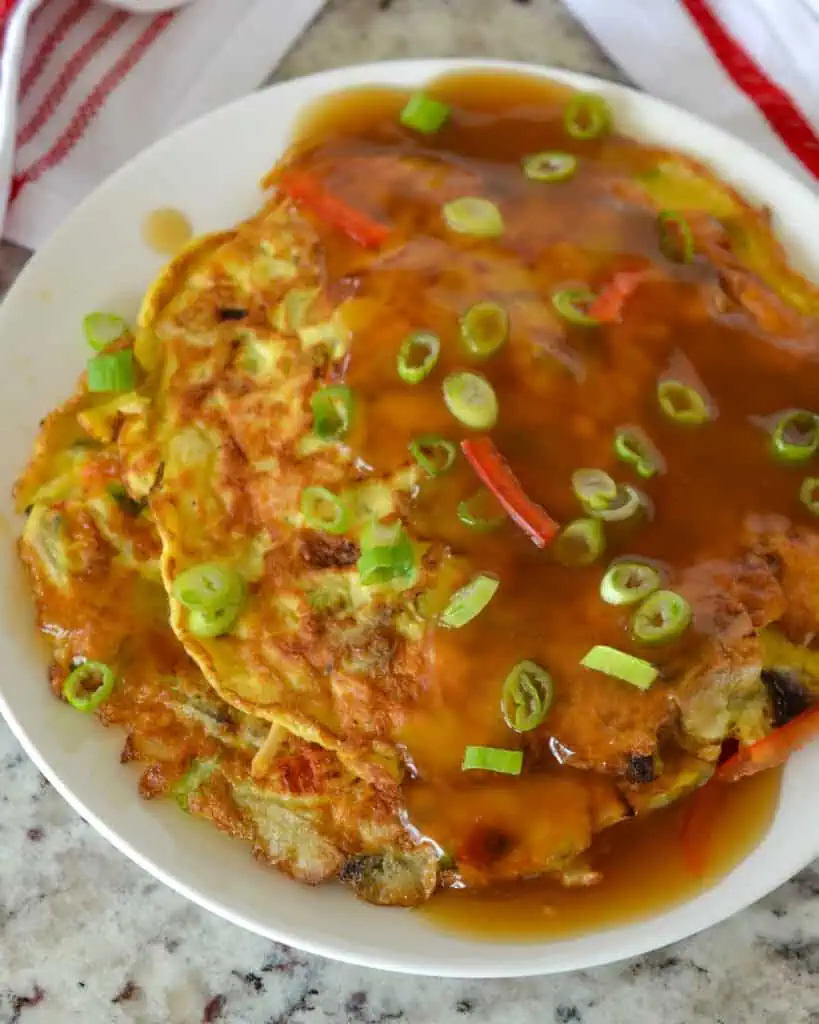 Two egg foo young patties with gravy and green onions. 