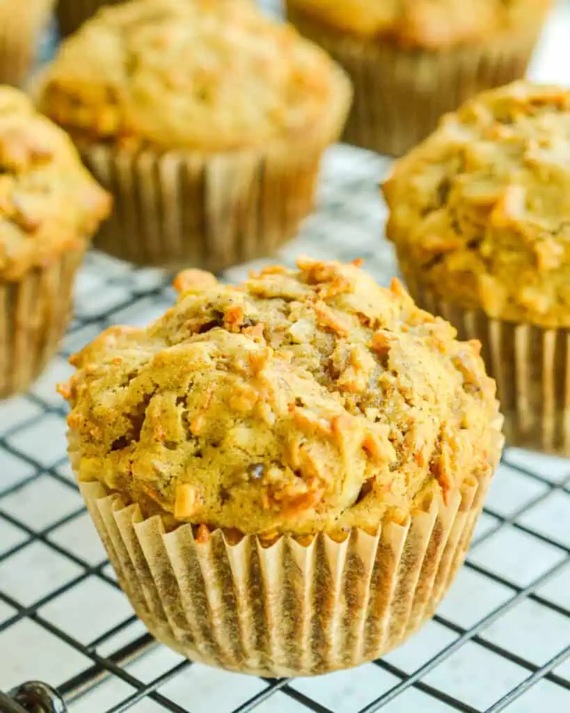 A batch of morning glory muffins on a cooling rack. 