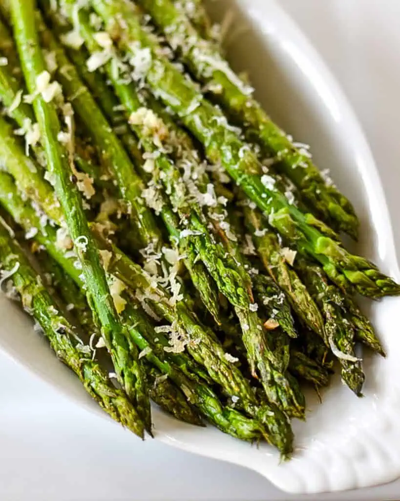 Oven roasted asparagus with garlic and parmesan in a serving bowl. 