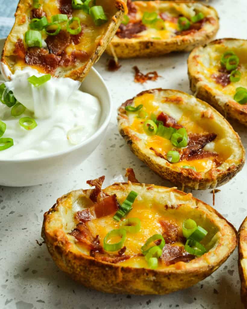 Fresh baked potato skins and a bowl of sour cream, 