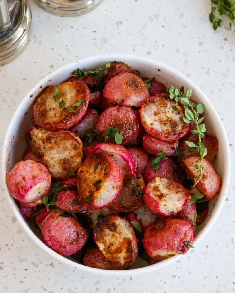 A bowl full of roasted radishes. 