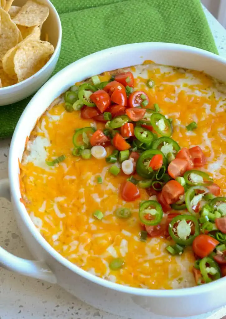 Warm bean dip with a bowl of tortilla chips on the side. 