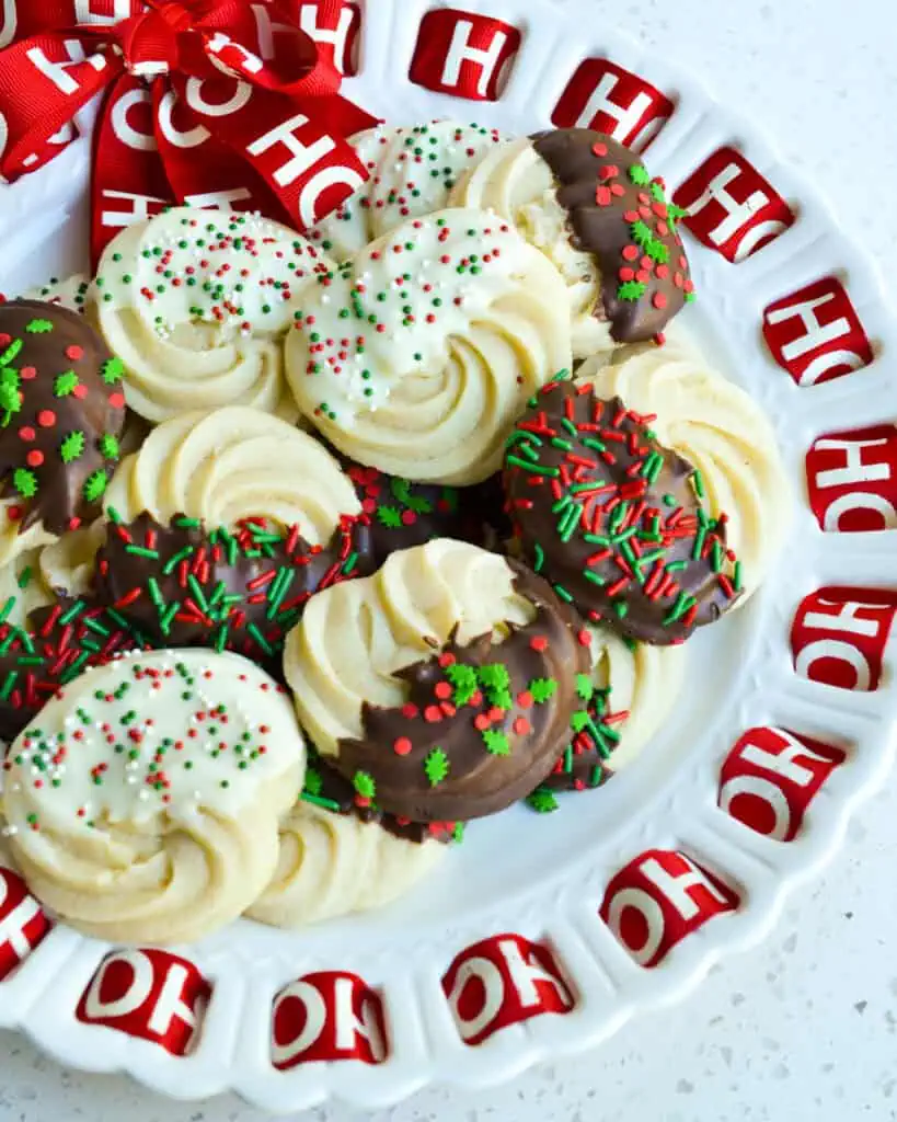 Assorted butter cookies with white and dark chocolate on a christmas platter. 