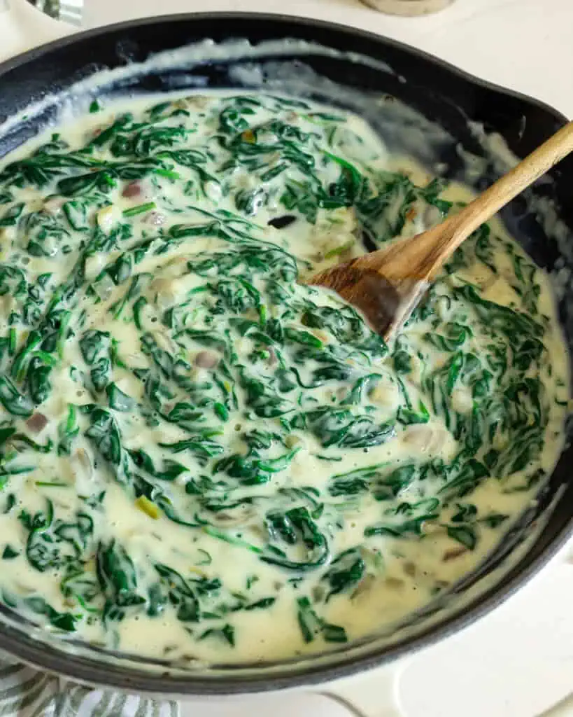 Homemade creamed spinach in a large skillet. 