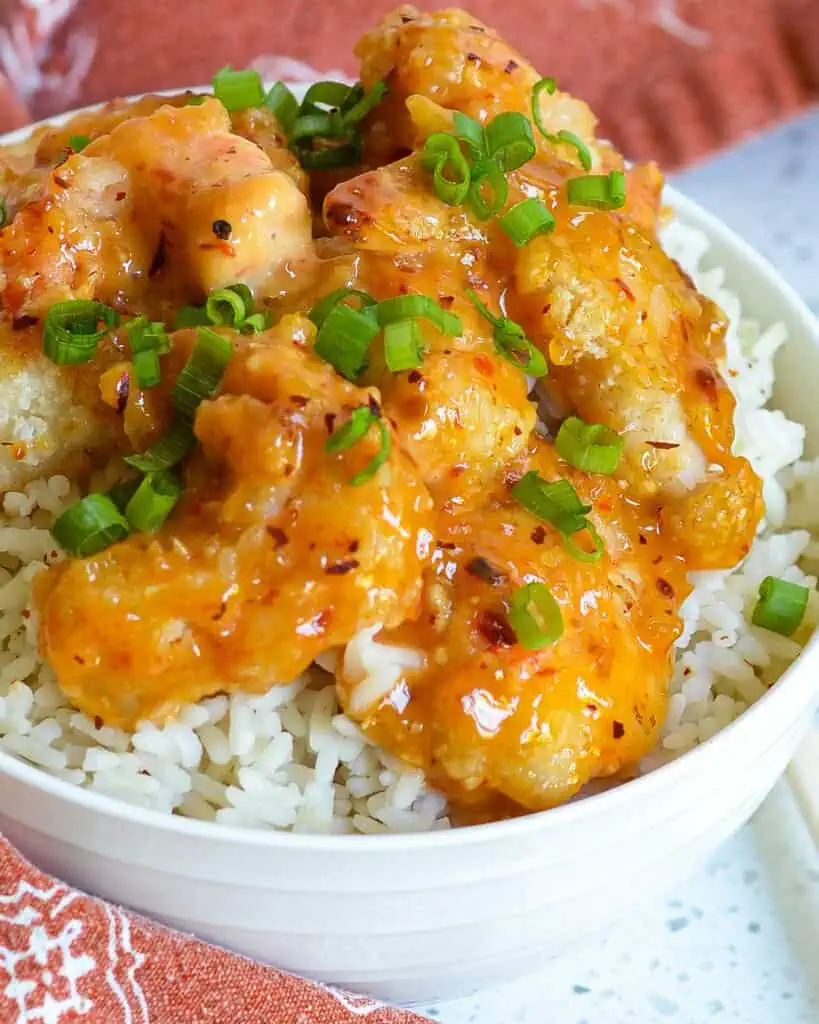 Bang bang shrimp over rice in a bowl. 