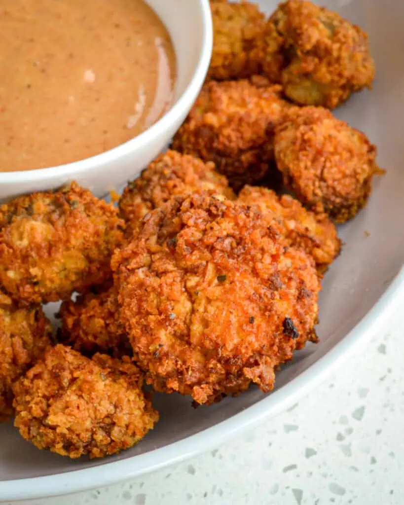 Crispy and slightly spicy fried white button mushrooms