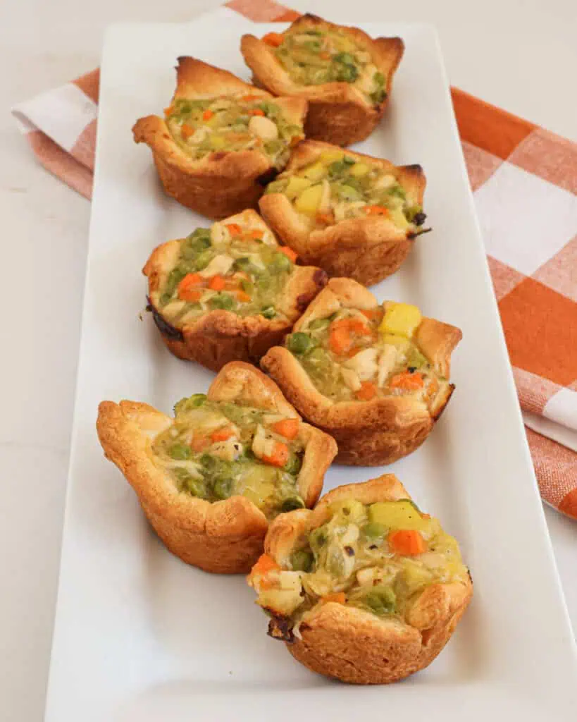 Mini chicken pot pies on a platter. 