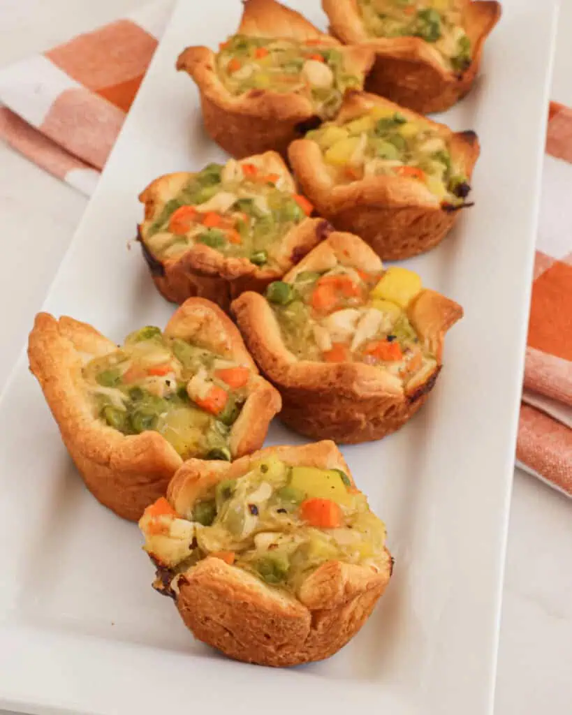 Mini chicken pot pies on a serving platter. 