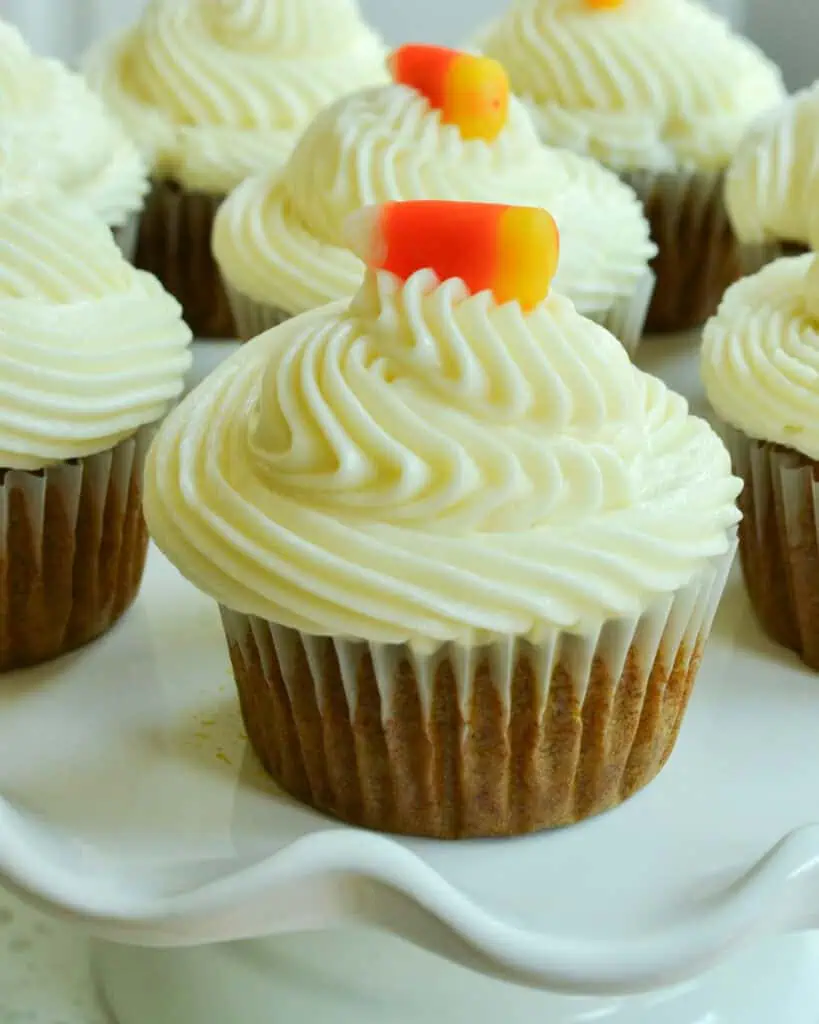 Pumpkin cupcakes on a cake stand. 