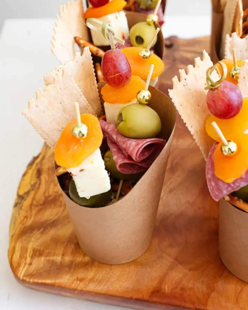 Charcuterie cups on a serving board. 