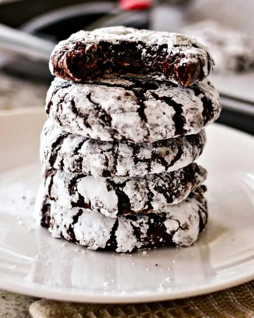 Stacked chocolate crinkle cookies on a plate, 