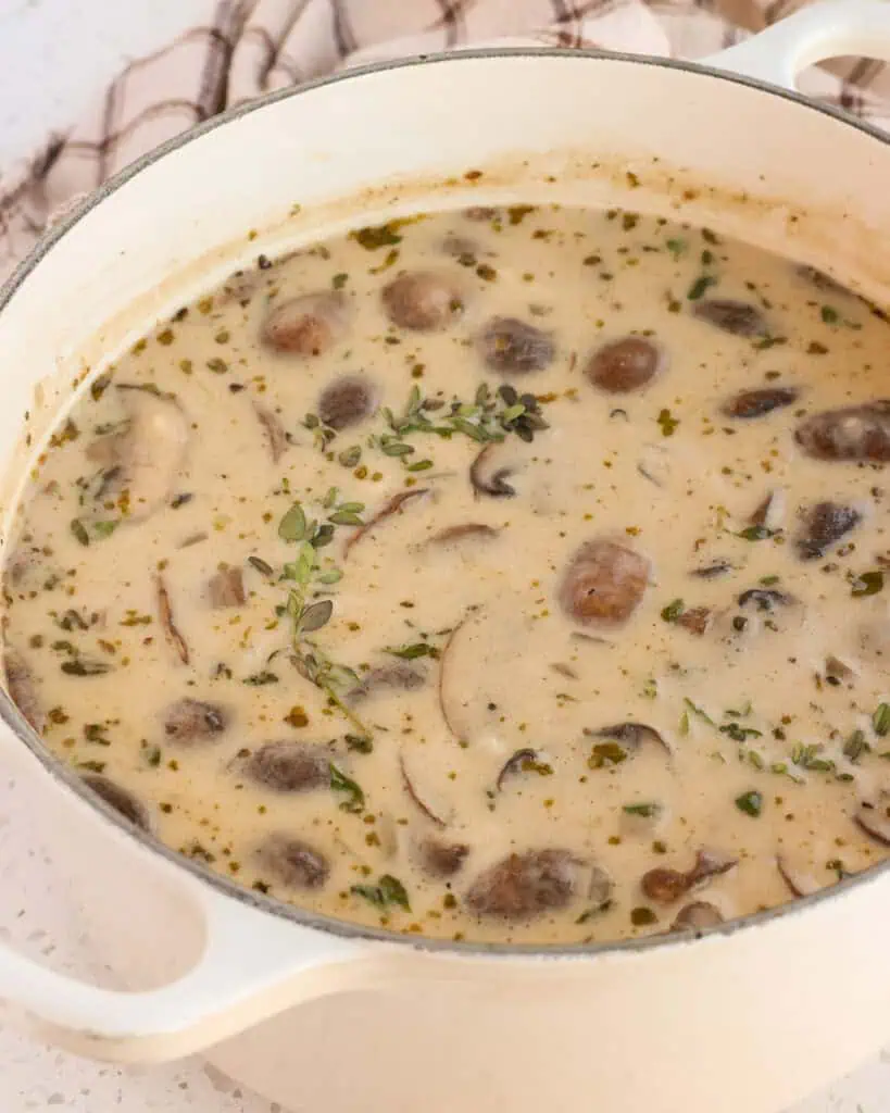 A Dutch oven full of homemade cream of mushroom soup. 