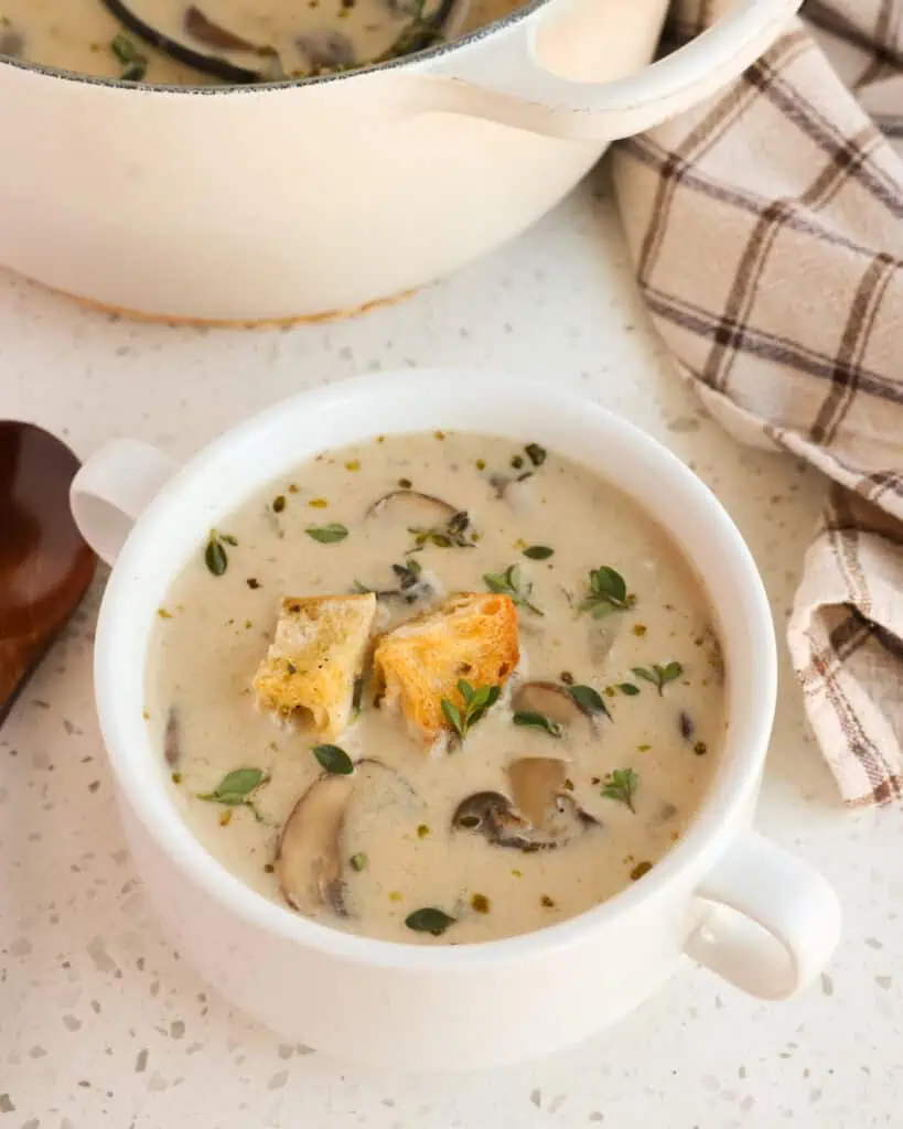 A bowl full of creamy mushroom soup with homemade croutons. 