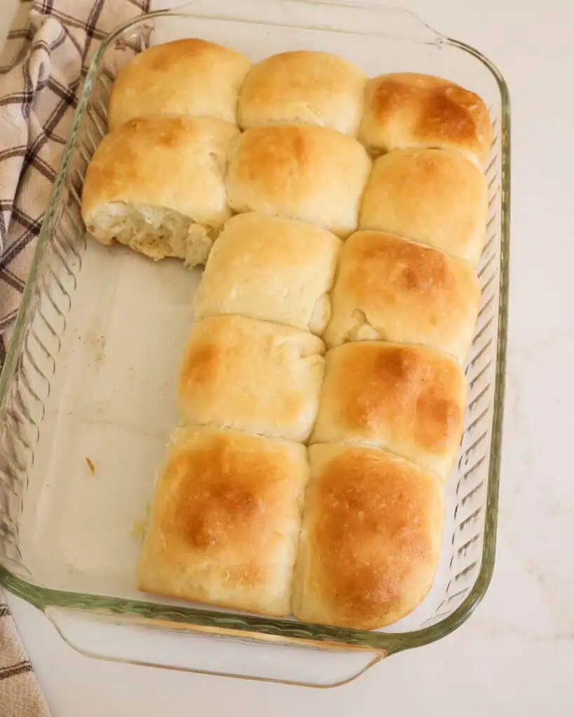 A 9x13 inch casserole dish filled with yeast rolls. 