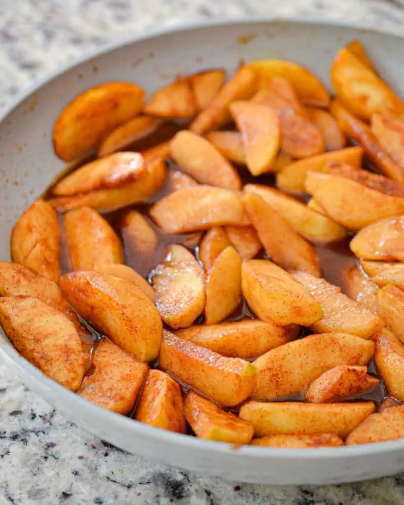 Fried apples with cinnamon and a skillet. 