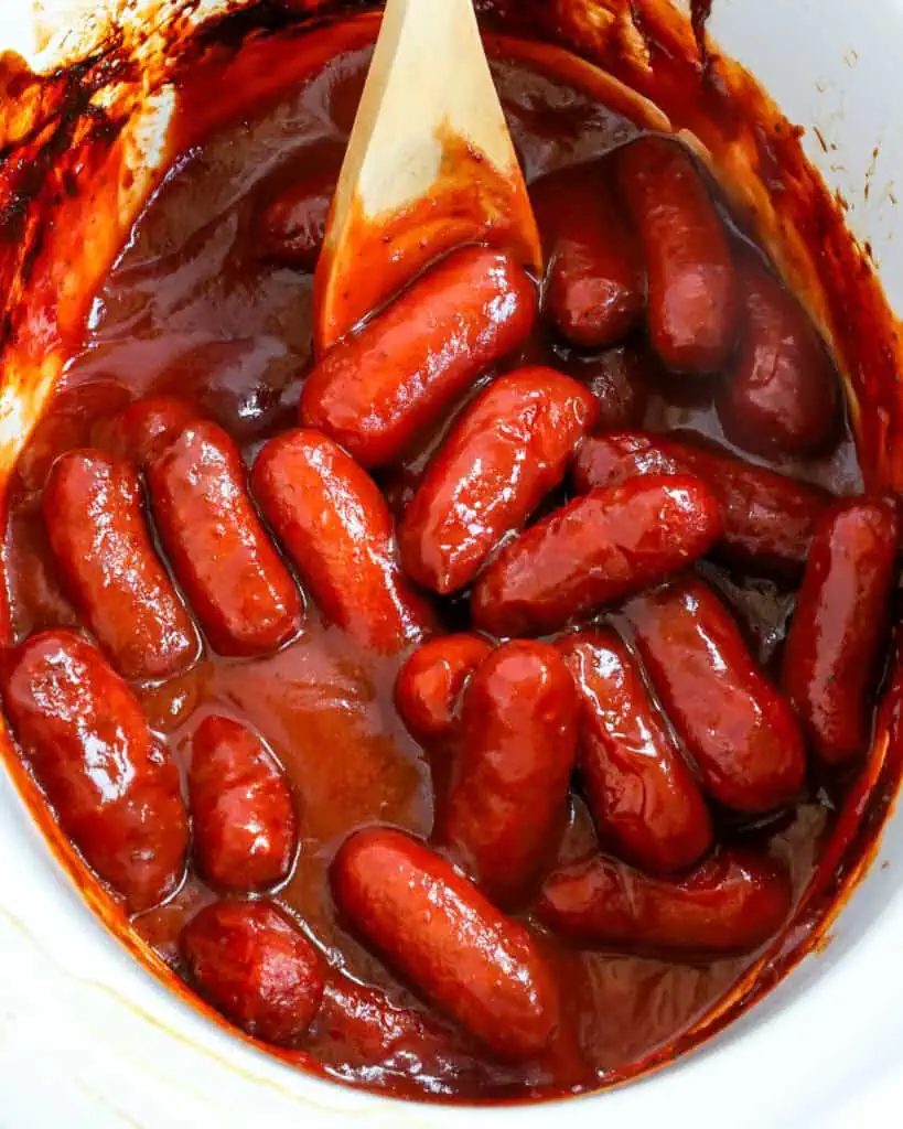 Little smokies in homemade sauce in a small crockpot. 