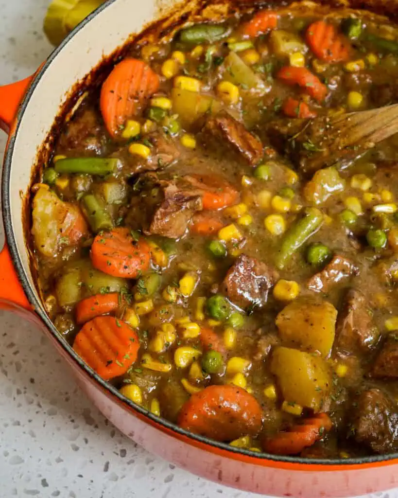 A close up view of Mulligan stew in a Dutch Oven. 