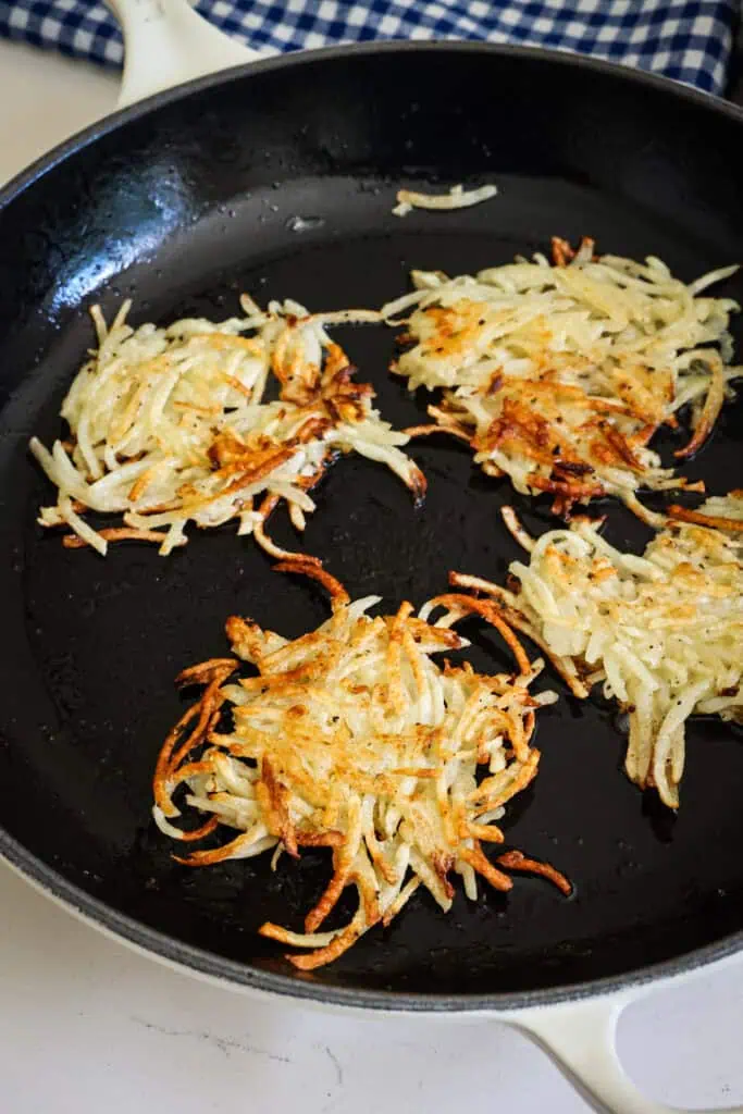 Browned potato pancakes in a cast iron skillet. 