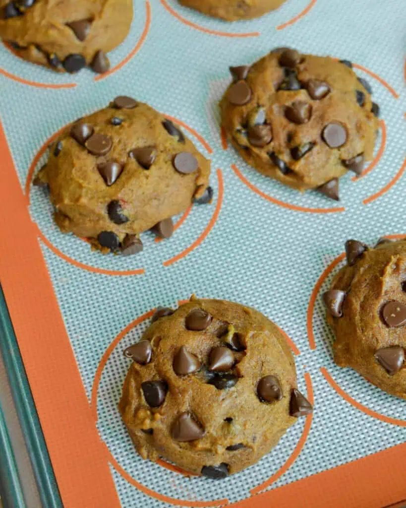 Fresh baked pumpkin cookies on a baking sheet. 