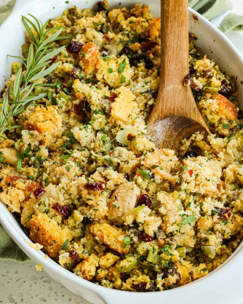 Classic Southern Cornbread Dressing made with homemade cornbread, ground sausage, onions, celery, dried cranberries, and plenty of fresh herbs. 