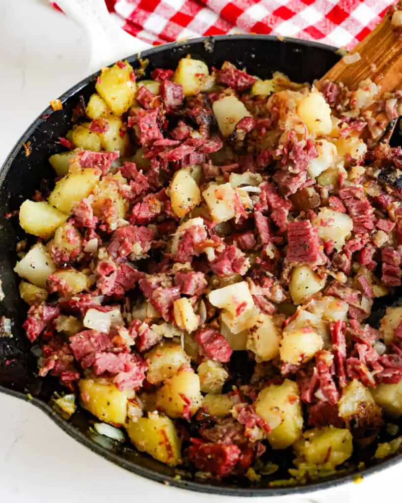 Corned beef hash in a large cast iron skillet. 