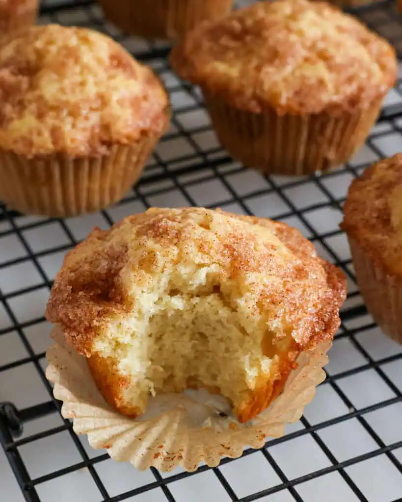 A close up view of a cinnamon muffin with a bite taken out of it. 