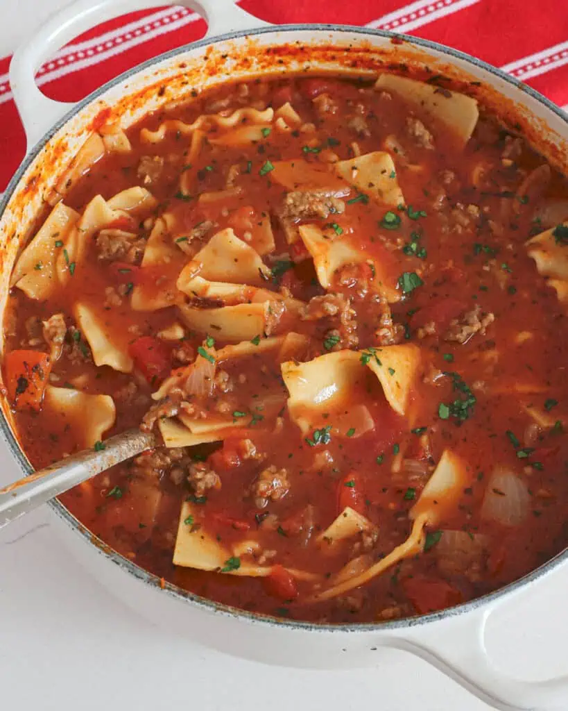 A Dutch oven full of simmered lasagna soup. 